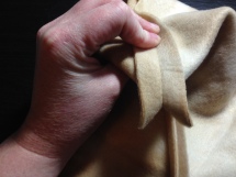 Optional steps for boxed corners: Pinch the corner together along the seam so that it forms a triangle at the bottom of the pouch. Match your bottom seam to your edge seam.