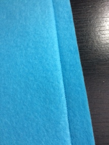This slide is showing a nice, even line of tight stitching. When you sew your pieces together, you want the tension on your machine great enough so that the thread sets itself into the fabric as shown. There should be no bunching, loops of thread, uneven stitches, or clumps of stitching in the line.