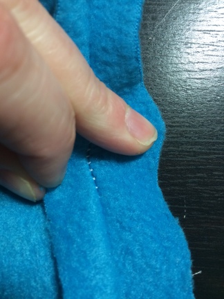 The tension on these stitches is too loose. When the seam is pulled apart, you can easily see the individual stitches. This could snag a nail and cause a hazard.